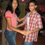 Mother and son dancing salsa.