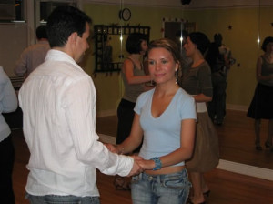 Young couple taking group salsa class.