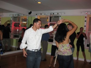 Miguel and salsera dancing at Dance Fever Studios' Party.