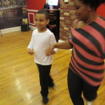 Christopher and Mother Lisa salsa dancing in Brooklyn dance studio in Park Slope